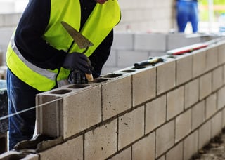 Contractor building a cement block wall